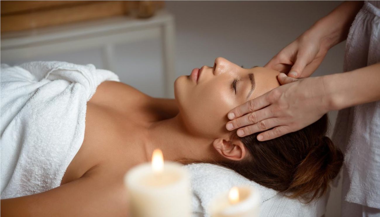 Young woman having face massage